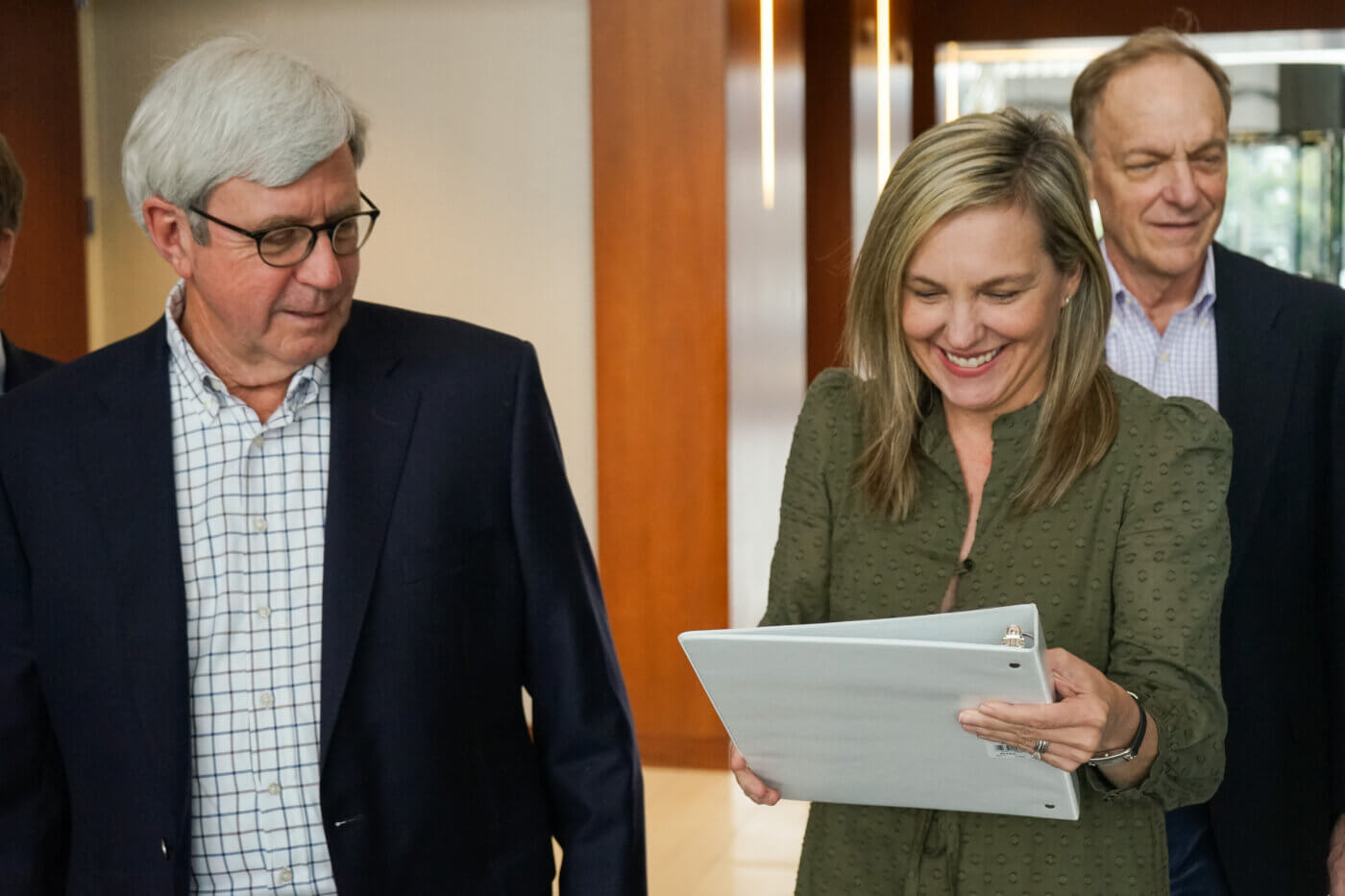 Maggie and Alan, two Yates employees, talking together looking at recent business insurance policy papers