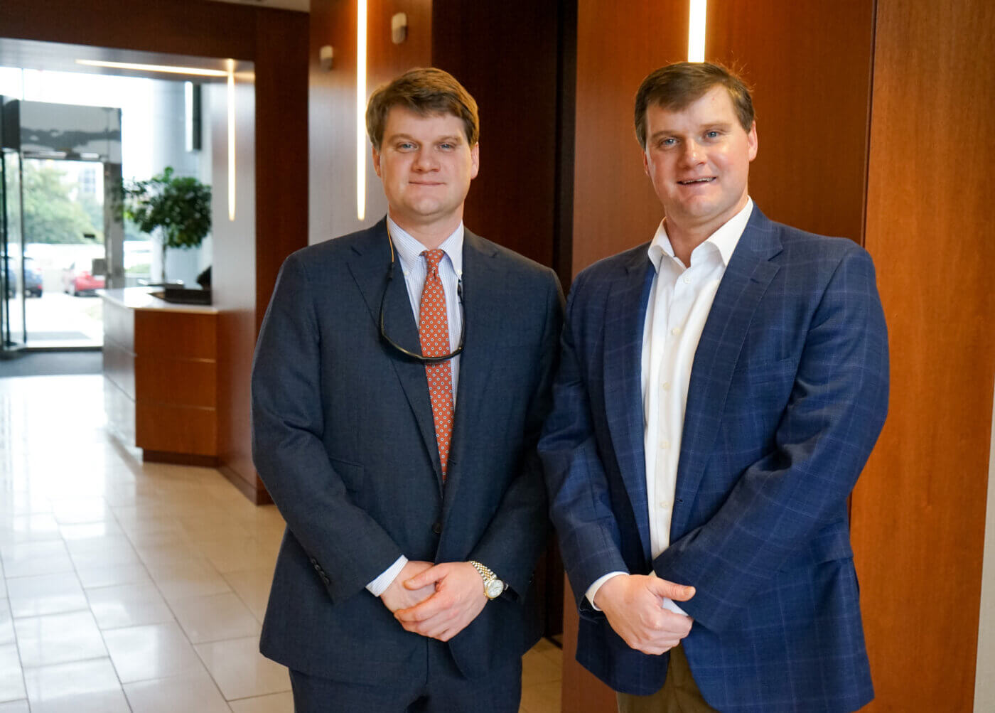 Two Yates employees, Carter and Robert, standing and smiling.