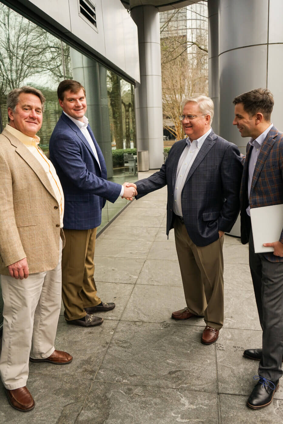 4 Yates employees, David, Carter, Jeff, Michael, standing outside of an office building.